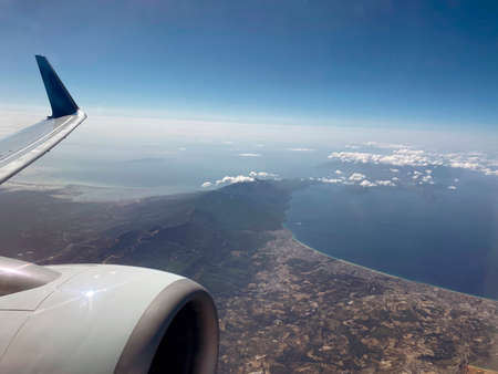 The engine, the wing of the plane and an incredibly beautiful view of the sea and the city from the...