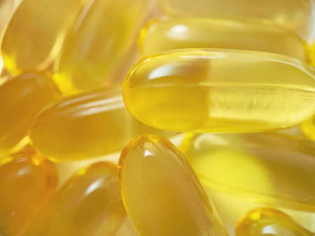 Close-up texture of many omega 3 capsules. Polyunsaturated fatty acids. The concept of a healthy...