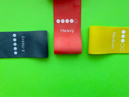 Fitness gum, elastic expanders on green background.Sport concept.Healthy lifestyle.の写真素材