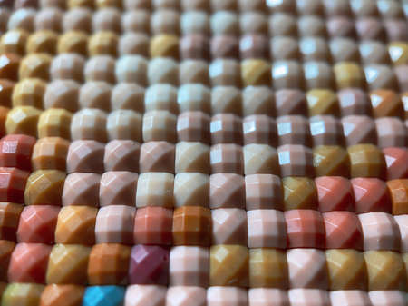 Close-up, colorful square diamond embroidery bright. Hobbies and entertainment.