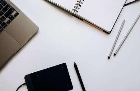 Layout for illustrators, designers, artists with a laptop, a graphic tablet with a stylus and a notepad with pencils.の写真素材
