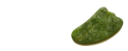 Guasha scraper for face and body massage isolated on white background. Beauty and personal care conceptの写真素材