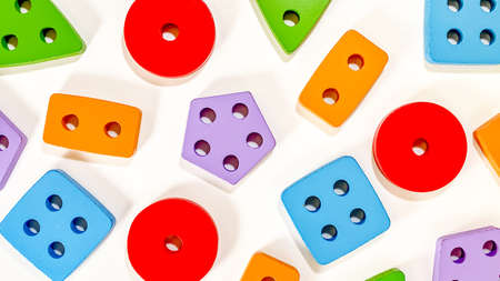 A layout of educational toys for small children in the form of multicolored sorters on a white background. Baby early development concept.の写真素材