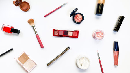 Beauty concept. Makeup products shadows, highlighter, blush, brushes, powder, glitter, mascara, gloss, lipstick, pencil on white backgroundの写真素材