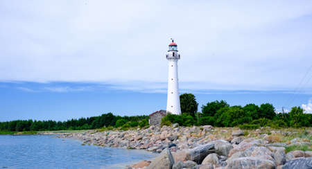 Beautiful lighthouse near the sea in a small village in clear weatherの写真素材