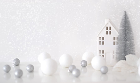 Christmas composition. Christmas balls white and silver, decorative house, christmas tree on a white backgroundの写真素材