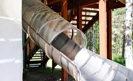 Childrens slide in the form of a pipe in an amusement park. Recreation and entertainment concept