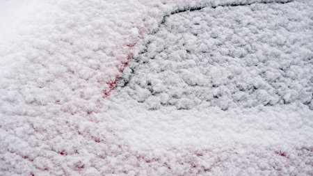 Close-up of snow frozen on a car. The concept of weather conditionsの写真素材