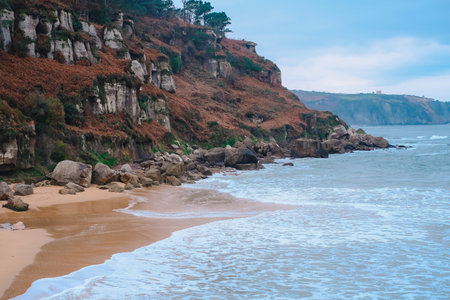 A rocky shoreline with a small body of water in the backgroundの写真素材