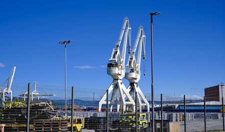 Two cranes are in the background of a blue skyの写真素材