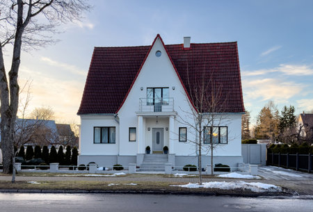 A beautiful, symmetrical white private house in Parnu, Estonia, photographed in late winter or early spring.の写真素材