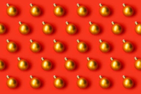 Pattern with golden Christmas tree decoration balls on a red backgroundの写真素材