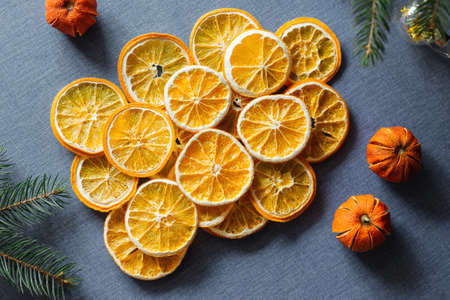 Dried oranges on blue background. Top view. Cozy winter decoration.