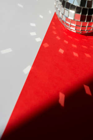 Christmas decorations, mirror disco ball with reflections on a white and red background.の写真素材