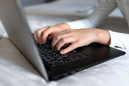 Person typing on a laptop. close up.
