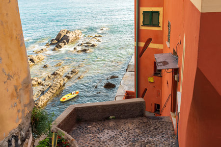 Fragment of an old European building with a bright colorful wall near the sea in Boccadasse, Italy...
