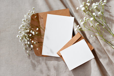 Aesthetic floral business brand template, blank paper cards and envelopes on a neutral beige background, mockup with copy spaceの写真素材