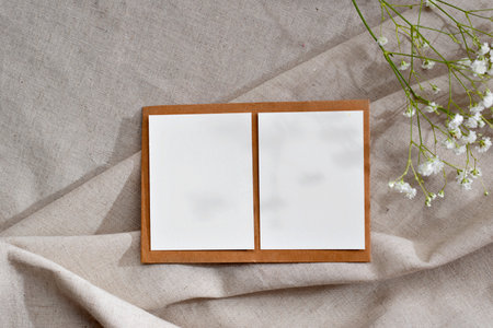 Minimalist aesthetic business branding template, layout with two blank paper sheet cards on a neutral beige linen textile background, copy spaceの写真素材