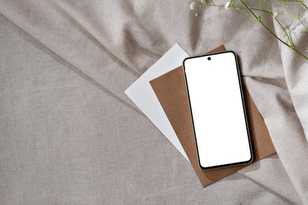 Mobile phone screen mockup, minimalist aesthetic business template with smartphone and paper cards on a neutral beige background, copy spaceの写真素材