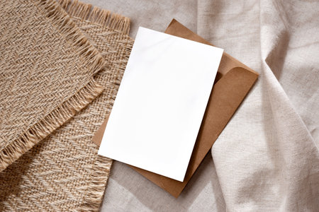 Elegant classic minimalist business branding template, blank paper card with mock up copy space on a warm neutral beige backgroundの写真素材