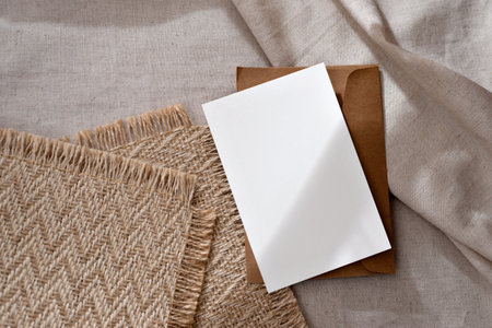 Aesthetic classic minimalist business branding template, blank paper card with mock up copy space and abstract sunlight shadows on a warm neutral beige backgroundの写真素材