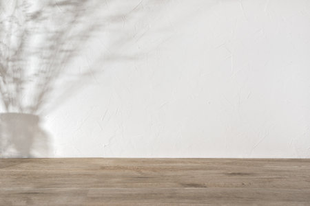 Flowers in vase shade silhouette on a neutral beige textured wall and floor background, aesthetic sun light shadow, empty template for home room interior product, mockup with copy spaceの写真素材