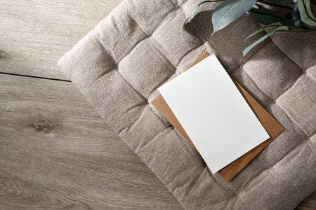 Blank paper card mockup, minimalist aesthetic business template with postcard and envelope on a beige interior pillow background, copy spaceの写真素材