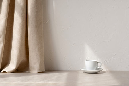 Aesthetic minimalist neutral home interior background, empty white wall, beige linen curtain, stone tabletop, coffee cup in a sun light raysの写真素材