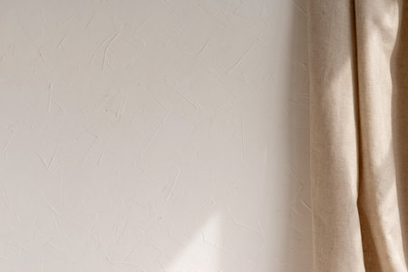Blank white wall with sun light ray and beige linen curtain, elegant neutral room interior mockupの写真素材