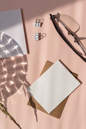 Blank paper card mockup, envelope, stationery on a light peach neutral background with sunlight shadow. Aesthetic business branding template, flat layの写真素材