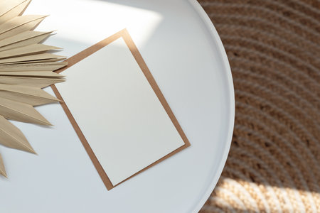 Minimalist elegant neutral business brand template, blank paper card with mockup copy space on white table with dried grass and sunlight pattern, beige rug, lifestyle natural background, flat lay.の写真素材