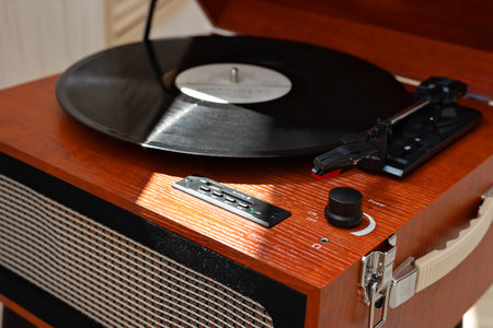 Brown wooden turntable with dusty vinyl record in sunlight. Retro vinyl digital player, nostalgic music modern trendの写真素材