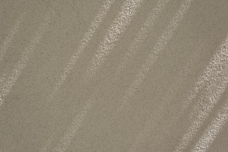 Minimalist natural sustainable background, business brand template. Aesthetic neutral dark beige blank concrete wall texture with long abstract sunlight shadow patternの写真素材