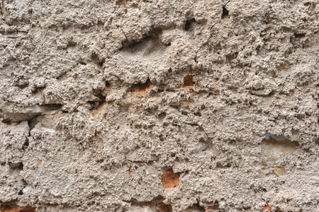 Authentic old rough building wall facade texture, antique architecture detail, vintage neutral beige house exteriorの写真素材