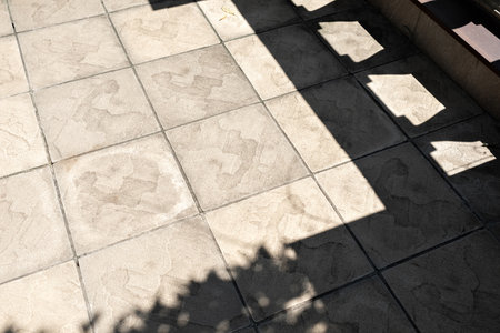 Aesthetic modern porch floor neutral beige tile pattern with a geometric lifestyle sunlight shadow. Modern luxury architectureの写真素材