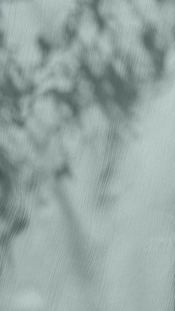 Abstract natural sunlight shadows on pastel sage green fabric texture, aesthetic vertical mobile...