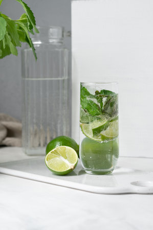Glass with mojito summer beverage on tray, fresh drink with lime and mint.の写真素材