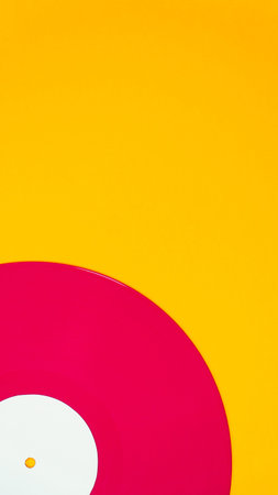 Red vinyl record minimal composition on bright yellow background. Retro audio concept with clean...