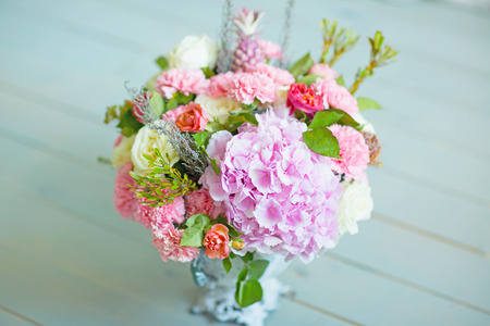 Wedding bouquet the top view on a light wooden background