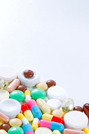 Vitamins, omega 3, cod-liver oil, dietary supplement and tablets an embankment on a light background close up, the top viewの写真素材