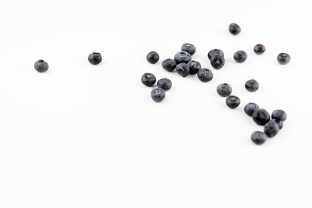 There are a lot of ripe big blueberries on a white photo background. Seasonal summer fruits.の写真素材
