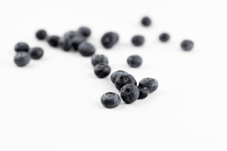 There are a lot of ripe big blueberries on a white photo background. Seasonal summer fruits.の写真素材