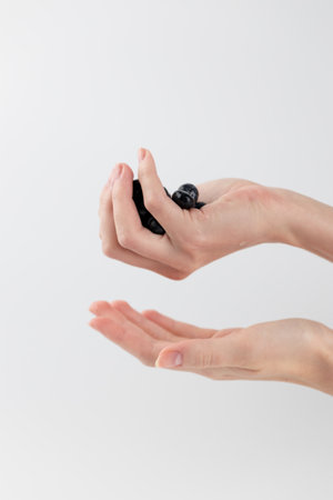 on a white photo background, large blueberries lie on women's palms, the hand insures the berries from falling, healthy vitamins, seasonal, summer fruitsの写真素材