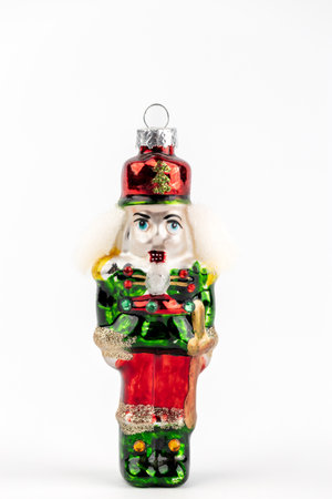 close up on a white background, a stand glass enameled Christmas tree toy, handmade, a tin soldier...