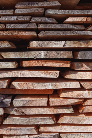 Background of dry chopped firewood logs stacked up on top of each other in a pileの写真素材