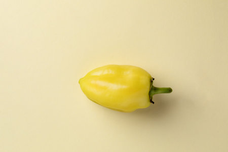 close-up photograph of an object on a light yellow background lies a freshly washed light yellow...