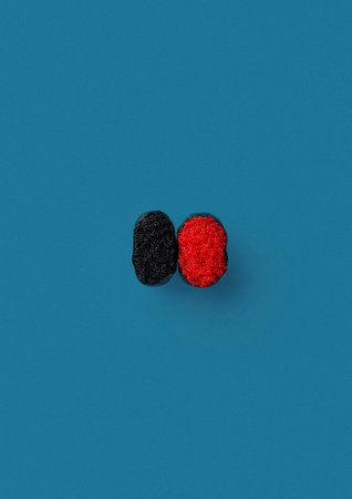 top shot on blue background lies set of two onigiri with black and red caviar wrapped in a sheet of noriの写真素材