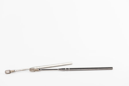 On a white background lie modern ear sticks with a spiral for removing dirt from the ear opening...