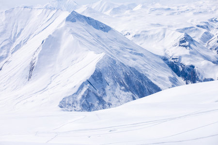 Beautiful Snow-Covered Mountains Under a Clear Blue Sky: A Serene Winter Landscape Capturing the...