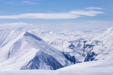 Stunning Winter Landscape: Majestic Snow-Covered Mountains Under a Clear Blue Sky Displaying the Beauty of Nature in Its Purest Form and Breathtaking Scenery All Aroundの写真素材